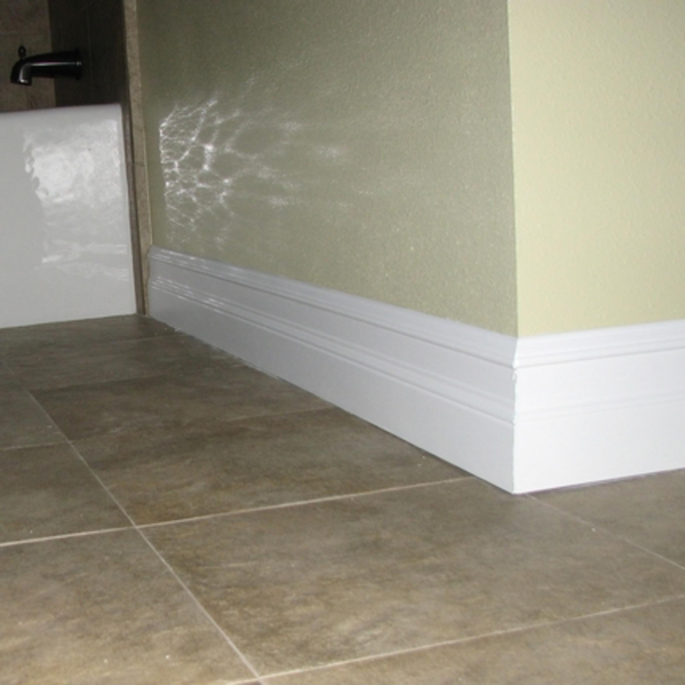 New tall baseboards, painted in a high gloss white to tie in the tub